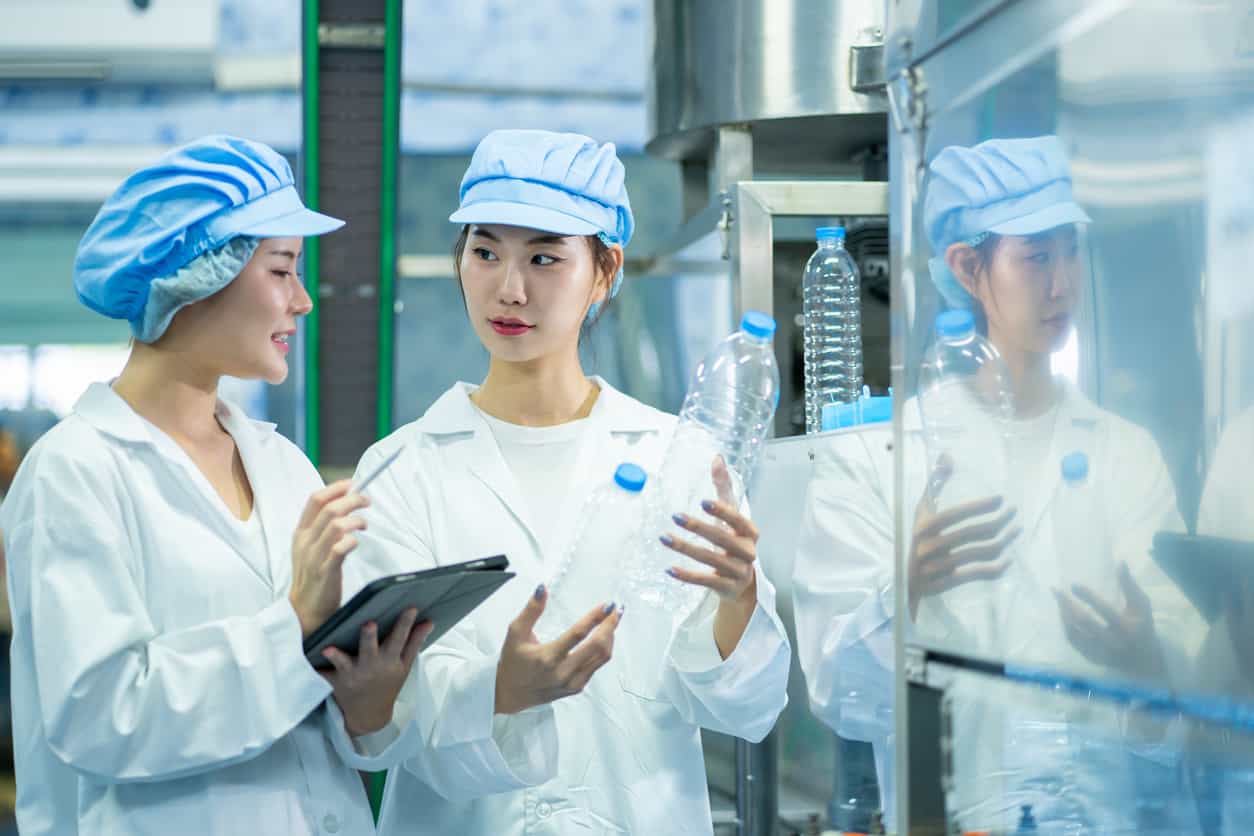 塑膠射出工廠中員工檢查瓶身品質與製造標準｜碩朗塑膠射出工廠